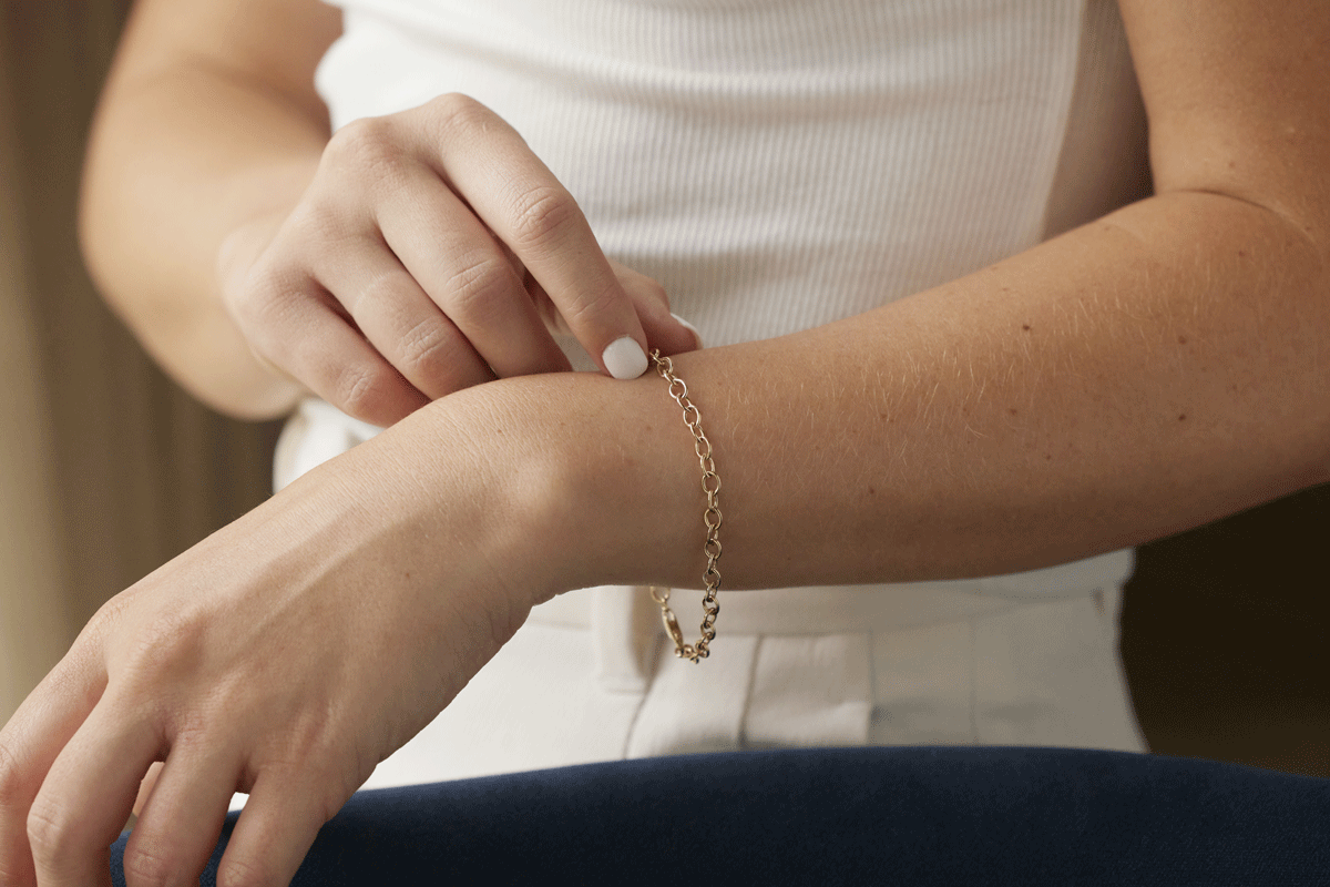 Woman's wrist with a gold chain bracelet