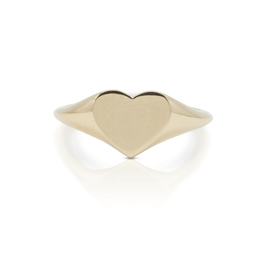 Gold signet heart ring on white background