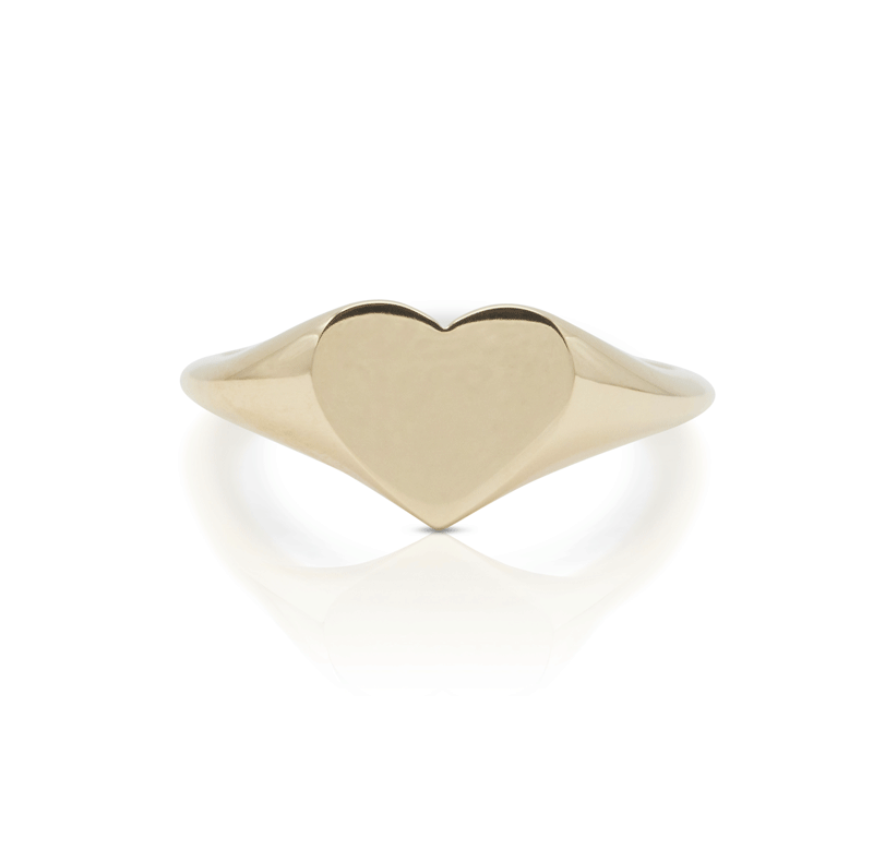 Gold signet heart ring on white background