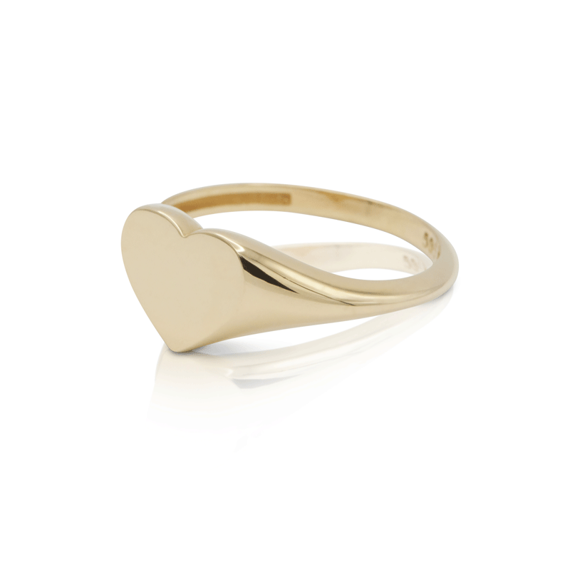 Gold signet heart ring band on white background