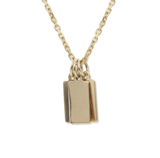 Tiny rectangular gold tag charms on a gold chain