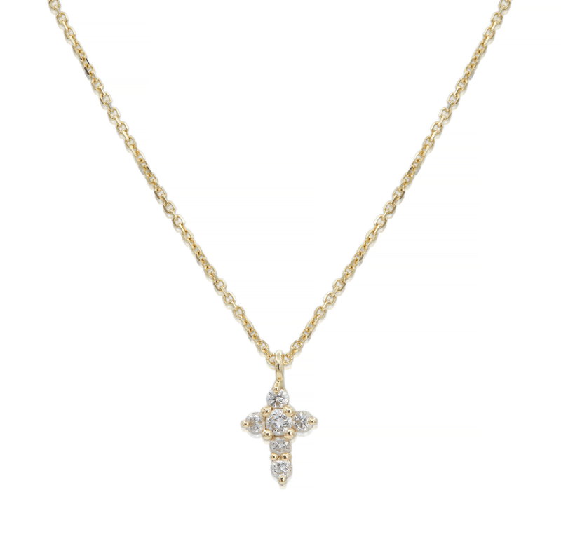 Tiny diamond cross pendant on a gold chain necklace