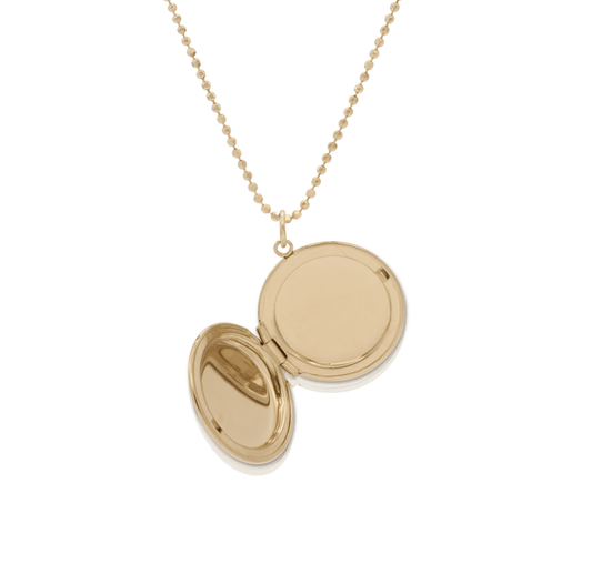 An open locket necklace in gold with beaded gold chain