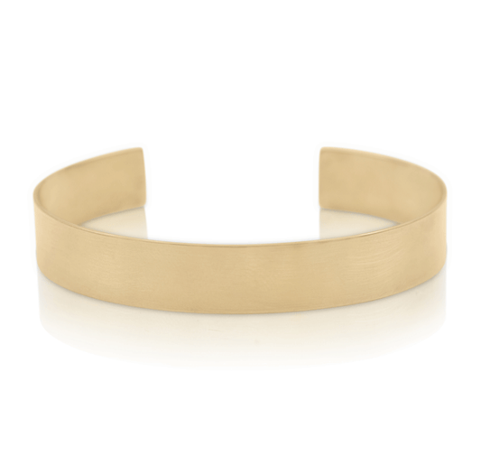 Thick gold cuff sculptural bracelet on white background