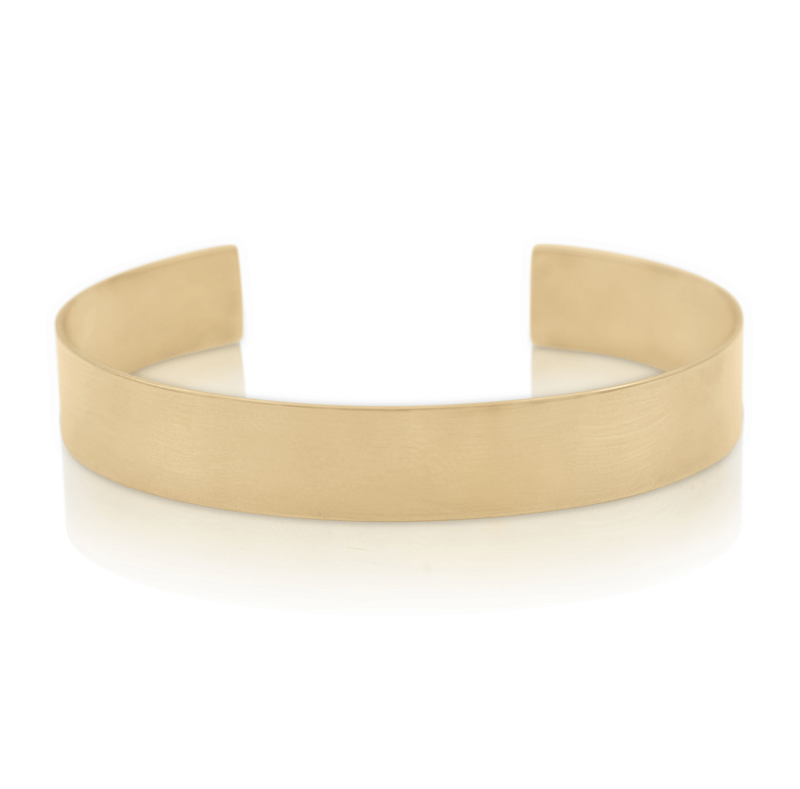 Thick gold cuff sculptural bracelet on white background