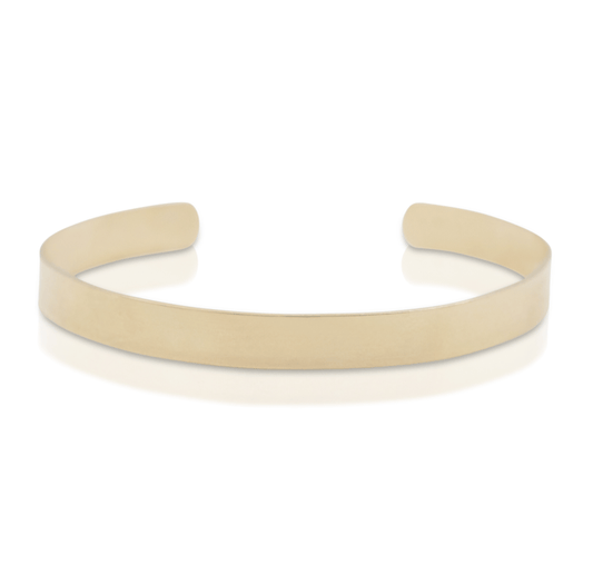 Flat gold cuff bracelet on white background