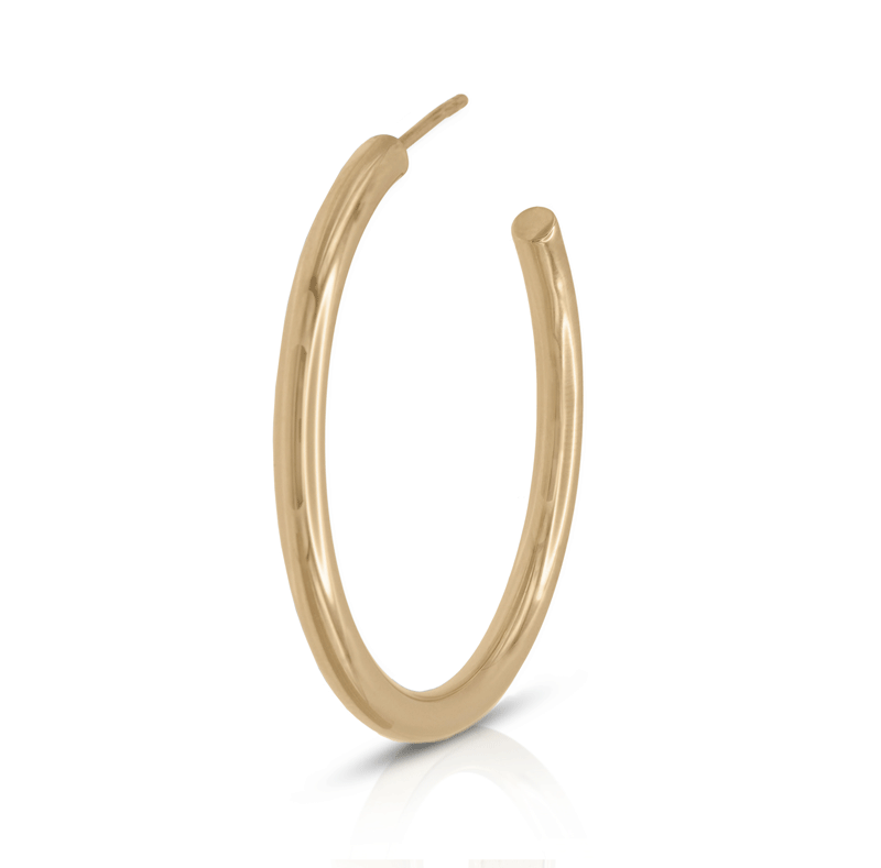 Medium gold hoop earring on white background