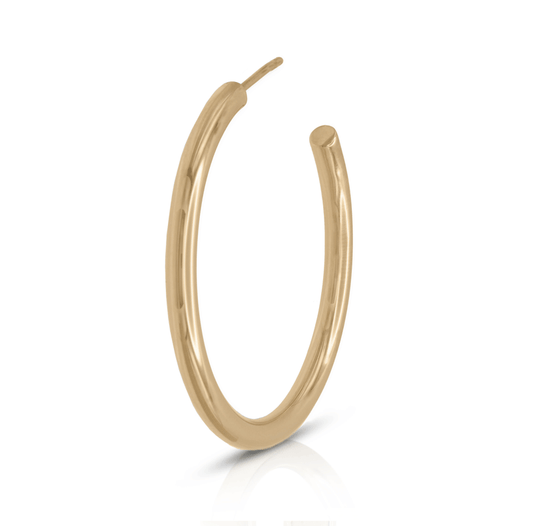 Medium gold hoop earring on white background