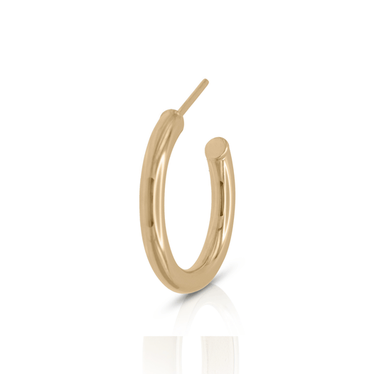 Small gold hoop earring on white background