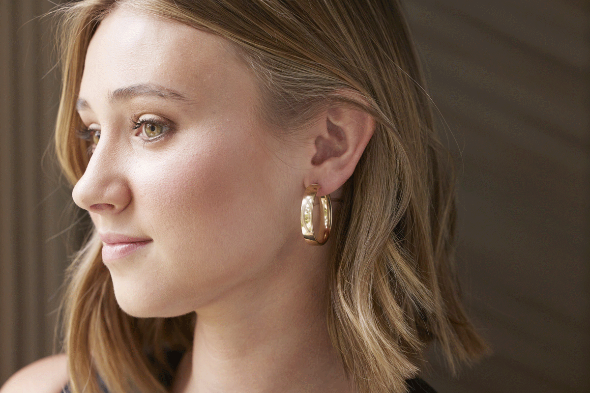 Girl wearing a thick gold hoop earring